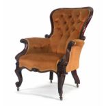 A Victorian mahogany and button upholstered armchair on scrolled feet CONDITION REPORT: Wear