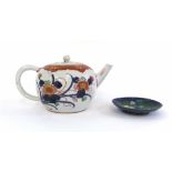 A Chinese ceramic teapot decorated with red and blue floral sprays, h.