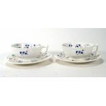 A pair of early 20th century cups and saucers, hand decorated with blue bells, marked '4852X' to