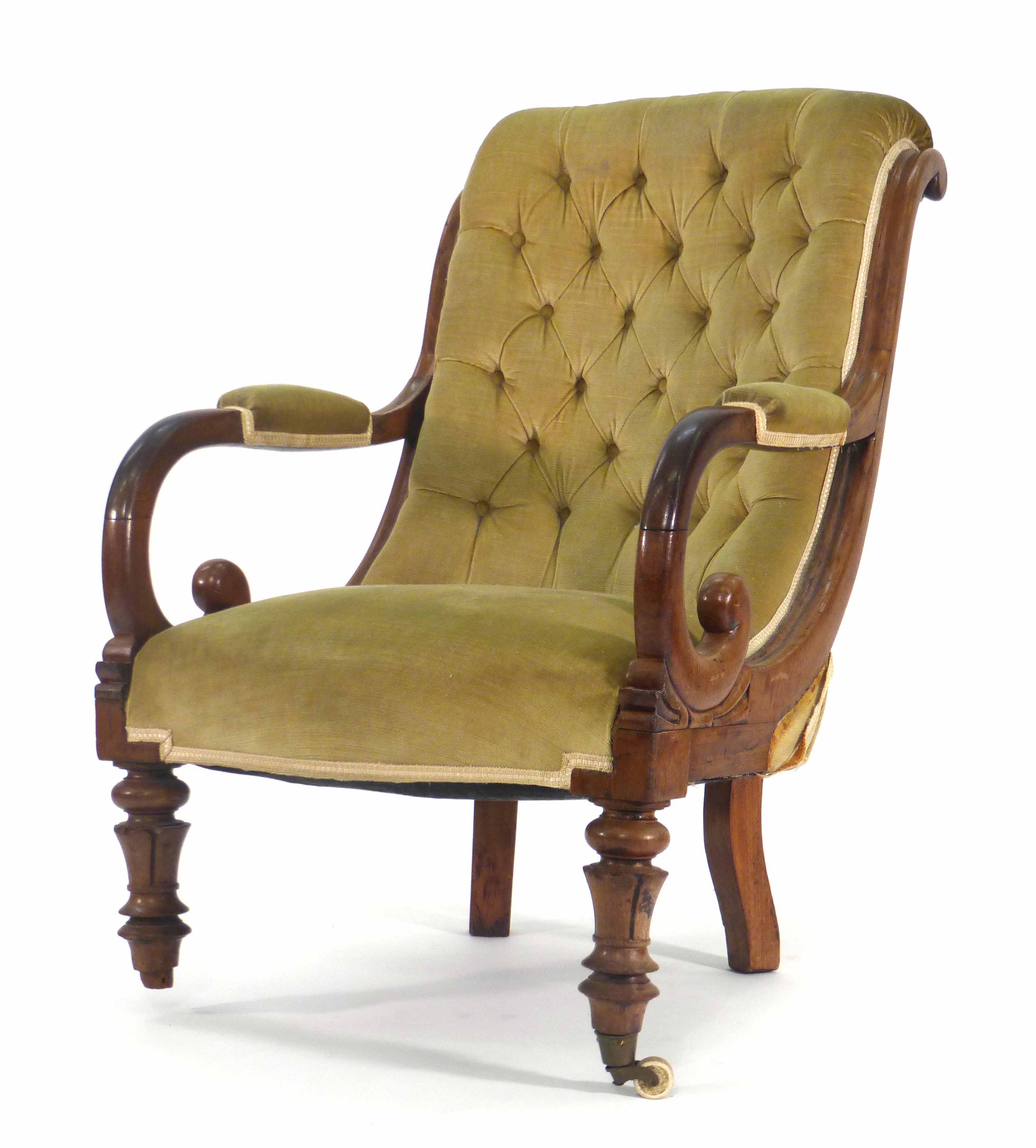 A Victorian mahogany and button upholstered armchair of scrolled form on turned feet CONDITION
