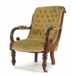 A Victorian mahogany and button upholstered armchair of scrolled form on turned feet CONDITION