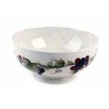 A Moorcroft bowl decorated with fruiting vines on a white ground, d. 21.5 cm, signature to base