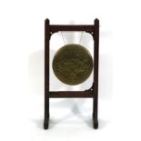 A Victorian brass dinner gong supported by an oak stand in the Gothic Revival manner, h. 107 cm