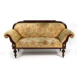 A late 19th century mahogany and upholstered two seater settee with brass motifs on turned feet