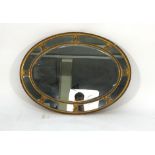 A 19th century wall mirror, the nine plates within a giltwood oval frame, 74 x 98 cm CONDITION