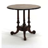 A 19th century yew, walnut and ebonised circular occasional table on three turned supports and three