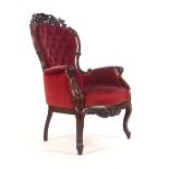 A Victorian mahogany and button upholstered armchair with shaped apron on cabriole feet CONDITION