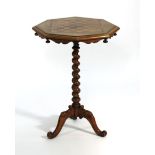 A 19th century walnut games table, the octagonal surface inlaid with a rosewood and walnut