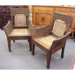 A pair of Anglo-Indian hardwood carver chairs with wickerwork seats CONDITION REPORT: Structurally