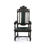 A 17th century-style oak and leather upholstered open armchair, the back rest with an armorial