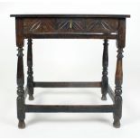 An 18th century and later carved oak side table, the single frieze drawer above turned legs joined