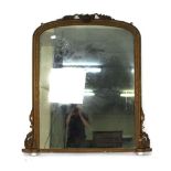 A 19th century overmantle mirror, the plate of rectangular cushioned form within a giltwood and