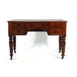 A Victorian mahogany writing table, the tooled leather surface over and arrangement of five