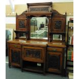 An Edwardian carved walnut breakfront sideboard, the mirror back over and arrangement of two drawers