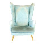 A 1960's turquoise vinyl wingback armchair on beech tapering legs, retailed by Heals, possibly