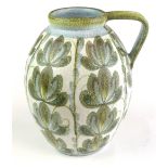 Glyn Colledge for Denby, a pottery jug decorated with green floral sprays on a white ground, h. 32