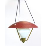 A 1970's red enamelled ceiling light with brass grill and glass shades supported below CONDITION