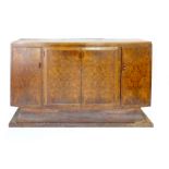 An Art Deco walnut dining suite by Wolfe & Hollander Ltd. of London, including a twin pedestal