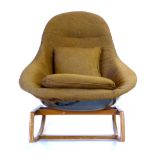 A Lurashell moulded fibreglass chair on a teak rocking base  CONDITION REPORT: Brown fitted covers