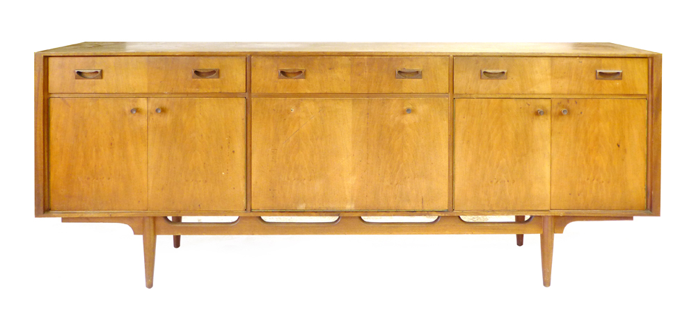 A 1970's McIntosh teak sideboard with three doors over a fall front door and two pairs of doors on