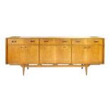 A 1970's McIntosh teak sideboard with three doors over a fall front door and two pairs of doors on