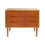 A teak chest of three drawers with integral handles on beech tapering legs, l. 77.5 cm CONDITION