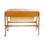 A Danish teak hobby table, the single fitted drawer over a wickerwork basket, l. 70 cm CONDITION