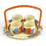 Clarice Cliff for Newport Pottery, a 'Crocus' pattern egg cup set including four cups and tray