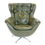 A 1970's green vinyl and button upholstered egg-type chair on an aluminium five star swivel base