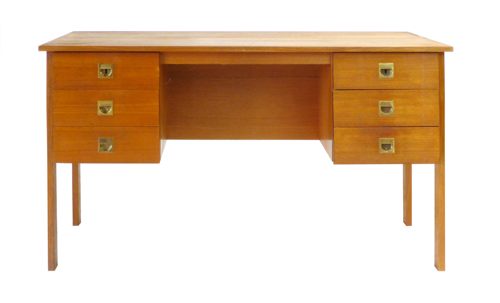 A 1970's teak desk with an arrangement of six drawers with brass handles on square straight legs, l.