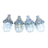 A set of four CCCP industrial bunker-type ceiling lights with steel grills and moulded glass