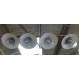 A set of four black enamelled ceiling lights with steel grills and moulded glass shades CONDITION