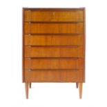 A Danish teak chest of six drawers with integral handles on circular tapering feet, w. 69 cm
