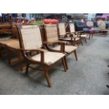 A set of four teak framed and wicker upholstered low lounge armchairs CONDITION REPORT: One