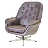 A 1970's brown leather and button upholstered swivel armchair on an aluminum five star base