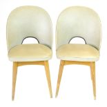 A pair of cream vinyl side chairs on beech circular tapering legs by Centa CONDITION REPORT: Burn