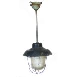 A set of four black enamelled ceiling lights on shafts with steel grills and moulded glass shades