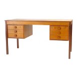 A teak twin pedestal desk with an arrangement of six drawers on square straight legs, l. 134 cm