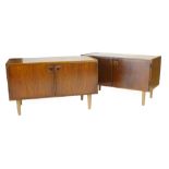 A pair of 1960's rosewood two door cabinets on beech circular tapering feet, l. 100 cm each