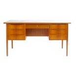 A 1970's teak and crossbanded twin pedestal desk with an arrangement of seven drawers on square