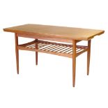 A 1960/70's teak metamorphic coffee/dining table with second spindle work tier, l. 110 cm  CONDITION