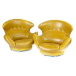 A pair of mustard vinyl and button upholstered low wingback lounge armchairs on castors CONDITION