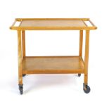 A Staples teak tea trolley with two detachable trays, l. 76 cm CONDITION REPORT: Structurally sound,
