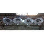 A set of four black enamelled ceiling lights with steel grills and moulded glass shades CONDITION