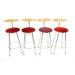 A set of four Italian bar stools with bent ply back rests, upholstered seats and chromed supports by