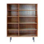 A 1960's rosewood open-fronted adjustable bookcase on black circular tapering legs, w. 120 cm