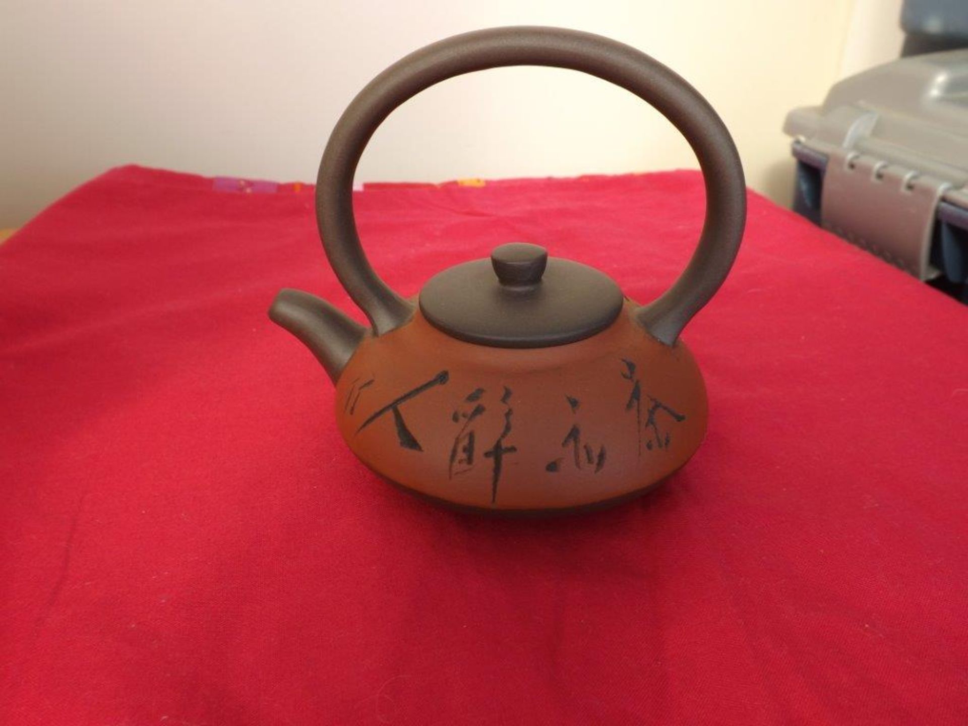 A Chinese Yixin Teapot of compressed form
Incised characters to body. Impressed seal markChinese