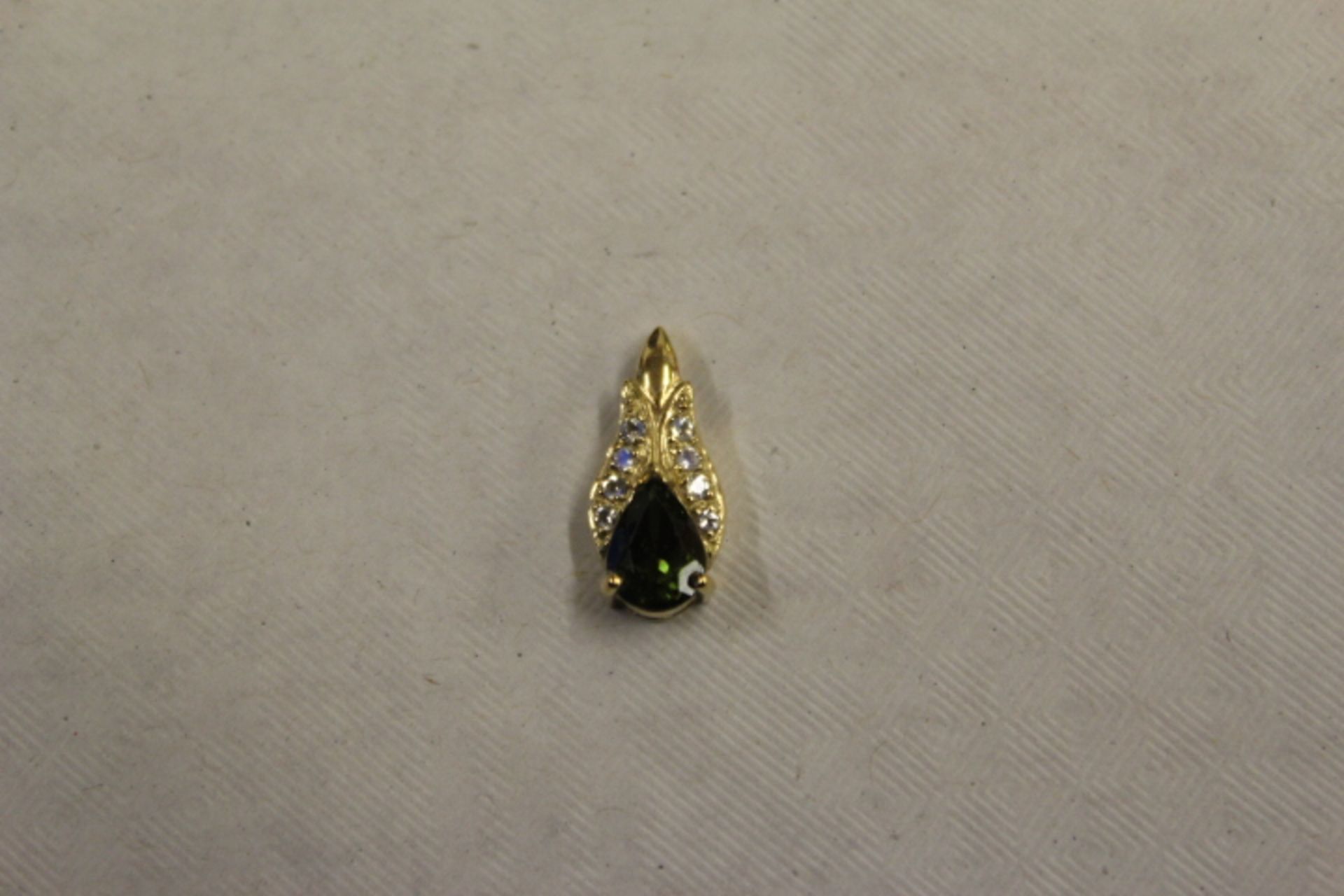 A 9ct Gold pear cut Tourmaline =0.796 carat  with 8 x rainbow moonstones= 0.117 carat Rainbow