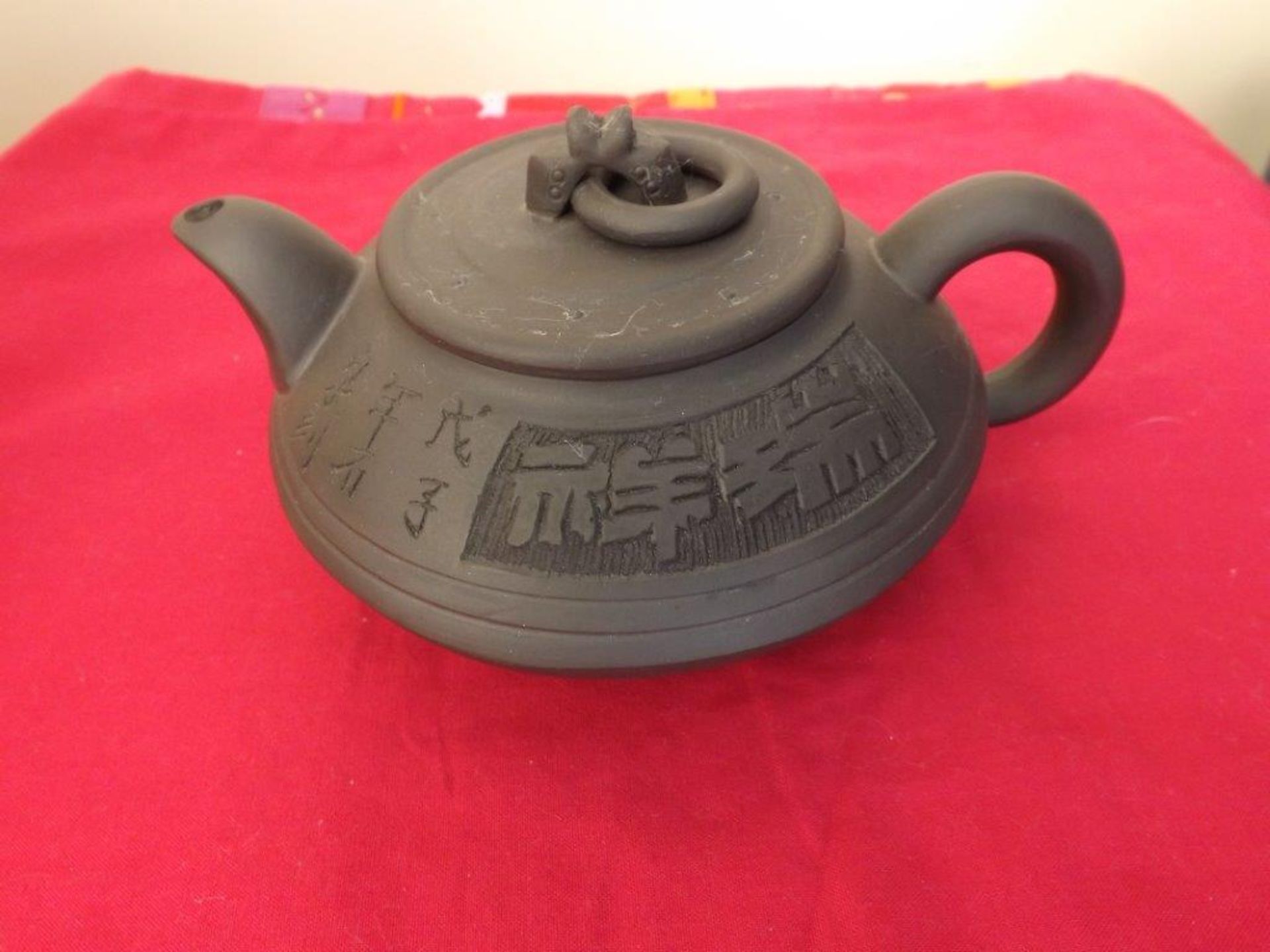 A Chinese Yixin Teapot of compressed form
incised character to body  Impressed seal mark