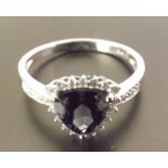 A stunning tanzanite and diamond ring, A trillion cut tanzanite stone surrounded by diamonds and set